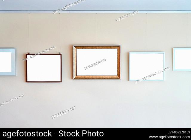 Empty picture frames on a gallery exhibition wall