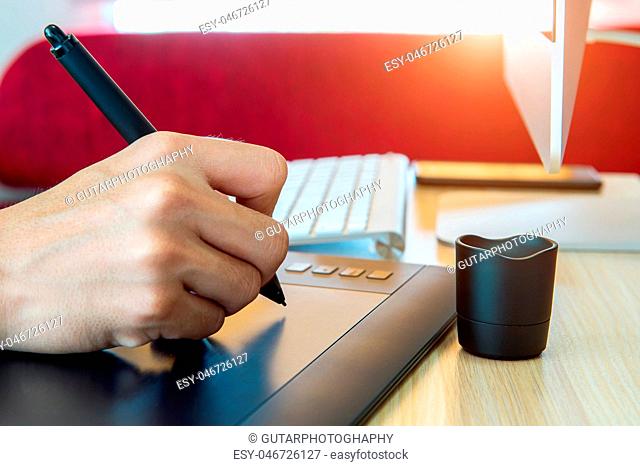 Graphic designer working with digital drawing tablet pen