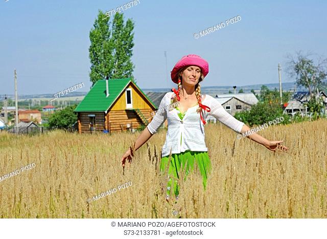 Woman and traditional russian house, Kuz'kino, Russian Federation