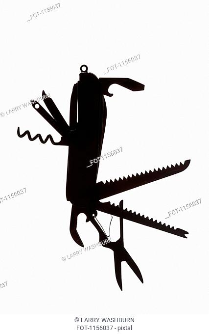 A multi-tool hanging in silhouette