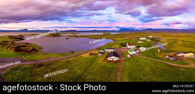aerial panoramic view of myvatn, iceland at epic sunset. volcanic craters in green plaints and link clouds and sky