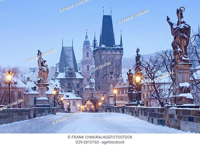 Prague - Charles Bridge tower nad St. Nicolas church on winter morning