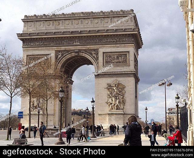 27 March 2021, France, Paris: The Arc de Triomphe (Arc de Triomphe) stands on the Place de l' Étoile, at the end of the Champs Elysees