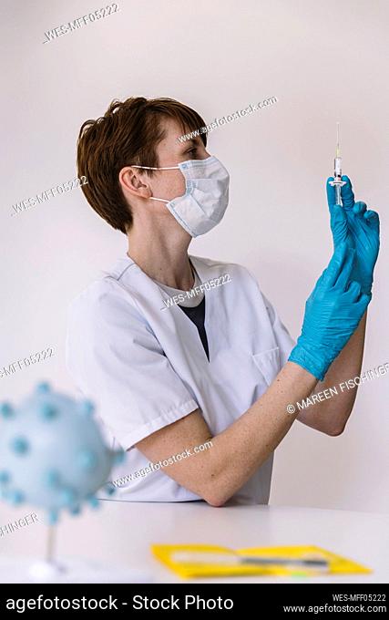 Doctor preparing injection with Corona virus vaccine