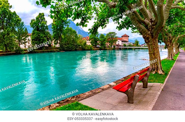 City park along the bank of Aare river in Old City of Interlaken, important tourist center in the Bernese Highlands, Switzerland