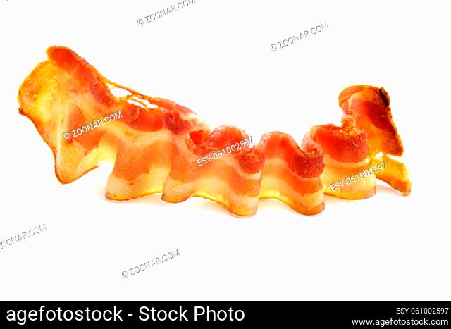 A rasher of fried crispy bacon ready to serve