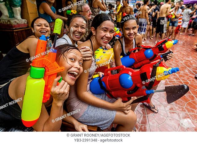 Local Girls With Water Pistols Taking Part In The Songkran Water Festival, Bangkok, Thailand