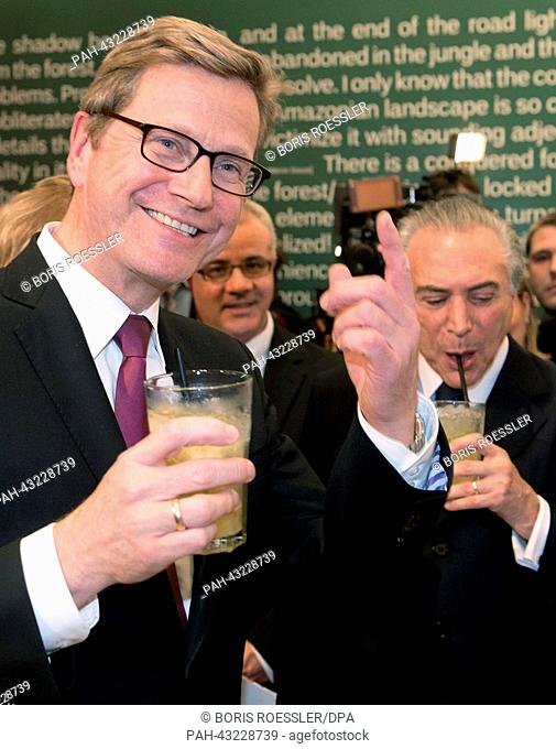 German Foreign Minister Guido Westerwelle (L) and Vice President of Brazil Michel Temer drink a cocktail as they visit the Pavilion of Brazil at the Frankfurt...