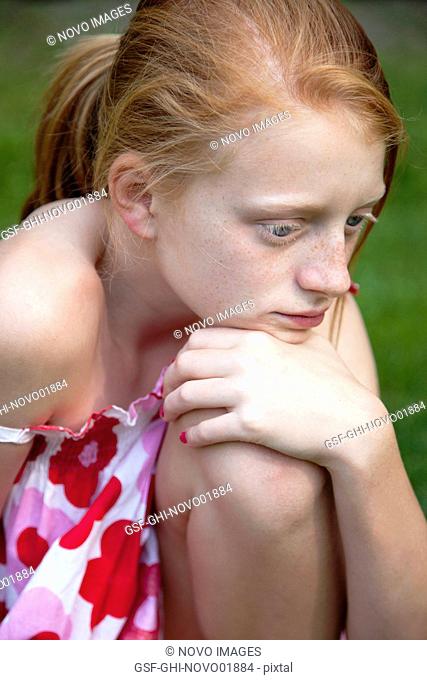 Young Girl Resting Chin on Knee, Portrait