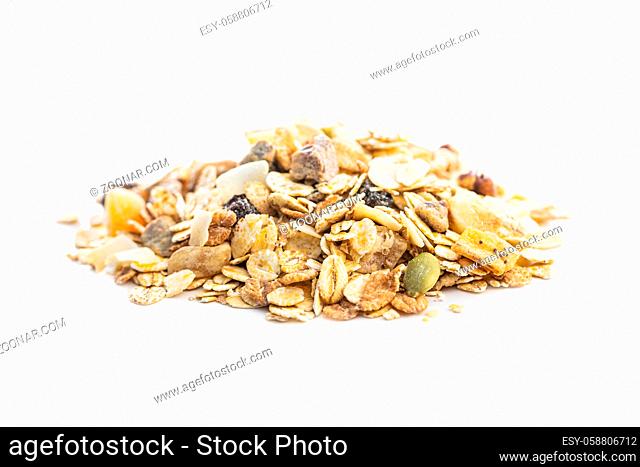 Beakfast cereals in bowl. Healthy muesli with oat flakes, nuts and raisins isolated on white background