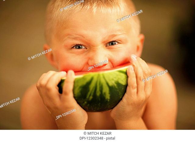 Boy Eating A Slice Of Watermelon