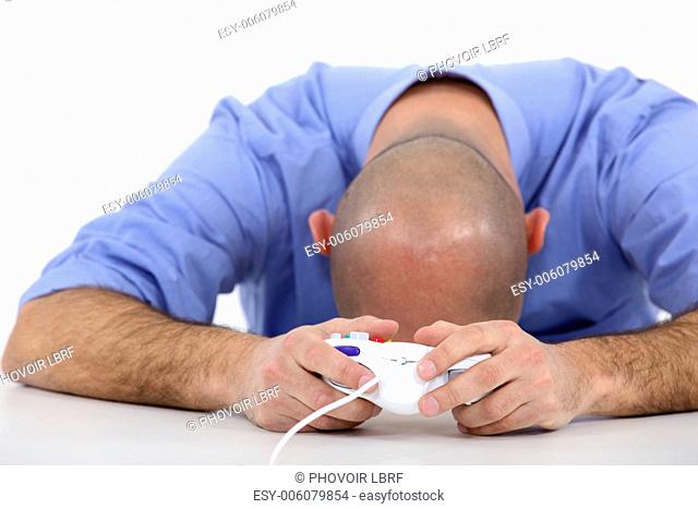 Stressed man playing video game