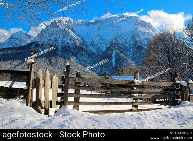 Winter walk near Mittenwald, the Karwendel mountains all in white, in the foreground a fence, atmospheric cloud mood, Europe, Germany, Bavaria, Upper Bavaria
