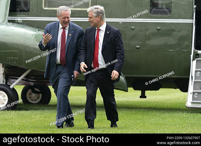 Mark Meadows, Assistant to the President and Chief of Staff and United States National Security Advisor Robert C. O'Brien walk across the South Lawn as they...