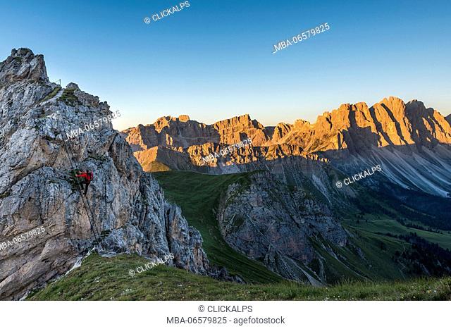 Funes Valley, Dolomites, South Tyrol, Italy, Climber on the Via Ferrata Günther Messner, In the background the Odle at Sunrise