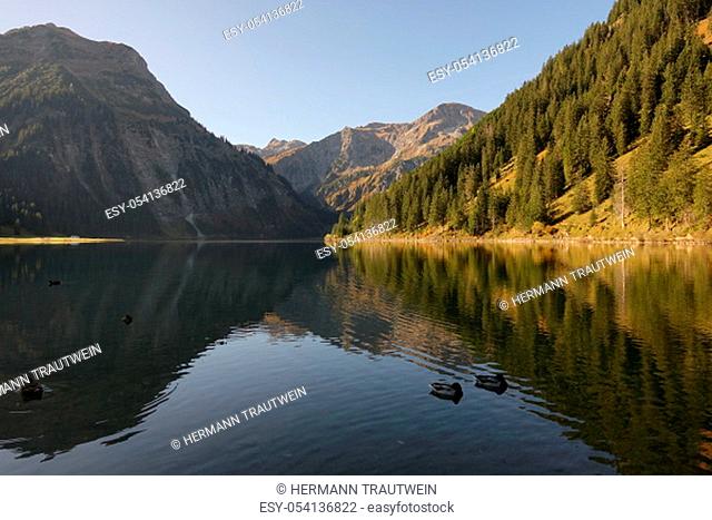 The mountains in the Tannheimer Valley in Tyrol / Austria are reflected in the clear waters of the Vilsalpsee
