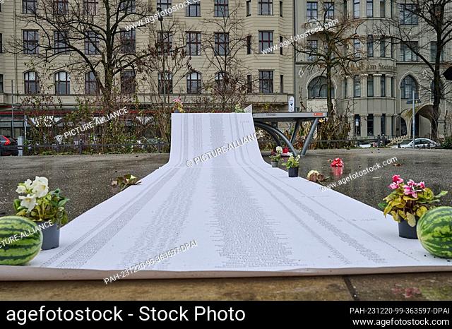 20 December 2023, Berlin: A meter-long roll of paper is supposed to show a list of names of people killed in the Gaza Strip