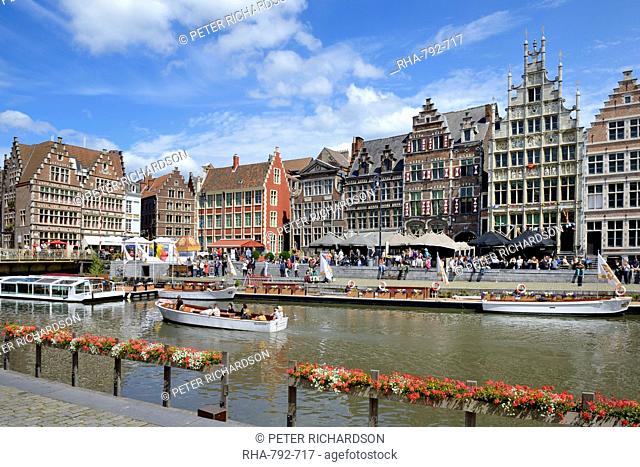 Tourists in sightseeing boats on River Leie and Medieval guild houses on Graslei Quay, Ghent, Flanders, Belgium, Europe