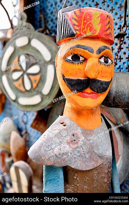 Close up of traditional, wooden, hand-made, brightly painted string puppet from Tunisia
