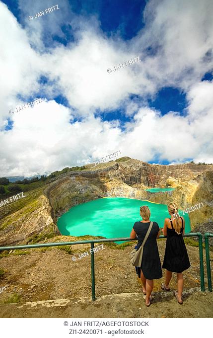 tourists at colourful volcanic lake of kelimutu volcano at flores indonesia