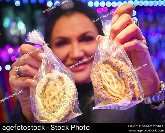 13 November 2023, Hamburg: A vendor holds ""pussy cookies at a stall called ""Warm moist and delicious"" at the ""Santa Pauli"" Christmas market on...