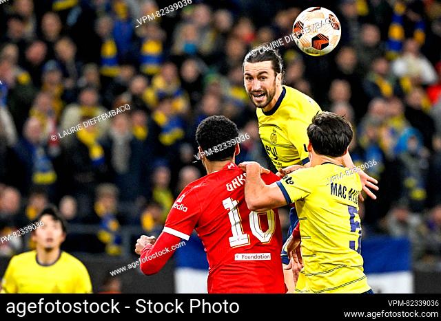 Union's Christian Burgess, Liverpool's Cody Gakpo and Union's Kevin Mac Allister fight for the ball during a game between Belgian soccer team Royale Union Saint...