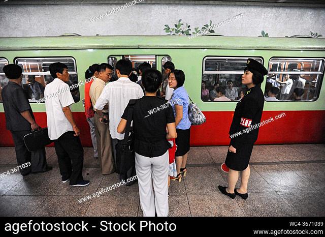 Pyongyang, North Korea, Asia - Commuters board a subway train of the Pyongyang Metro at an underground station in the centre of the North Korean capital city