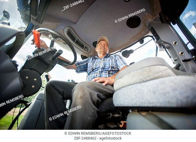 Earl Buddy Hance, Secretary of Agriculture inside a tractor cab near Port Republic, Maryland, USA