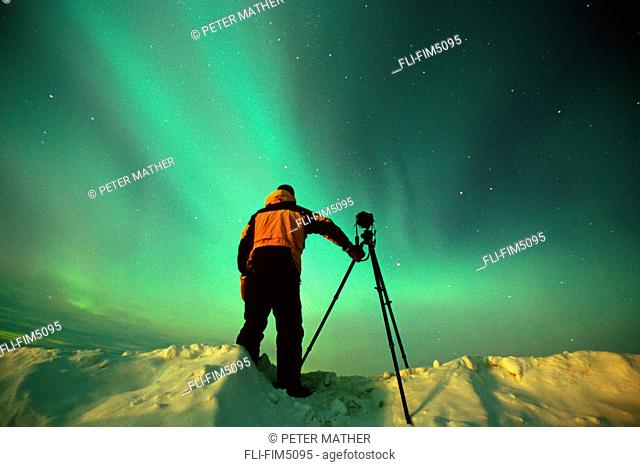 Photographer under the Aurora Borealis, Northern Yukon
