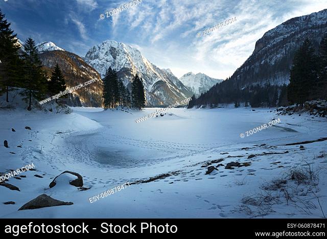 Frozen and snow covered in winter Lago del Predil beautiful alpine lake in north Italy near the Slovenian border. Julian Alps Italy