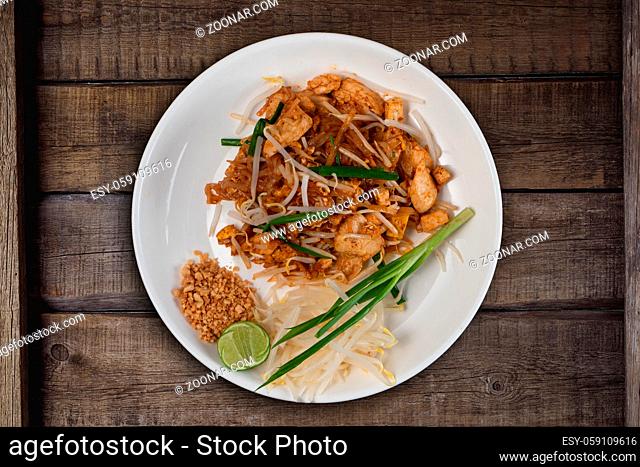 Top view Thai food Pad Thai chicken isolated on rustic wooden table