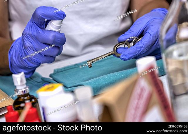 Scientific police officer examines keys of test of scene of crime, conceptual image