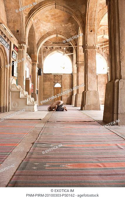 Man praying in a mosque, Siddi Sayed Mosque, Ahmedabad, Gujarat, India