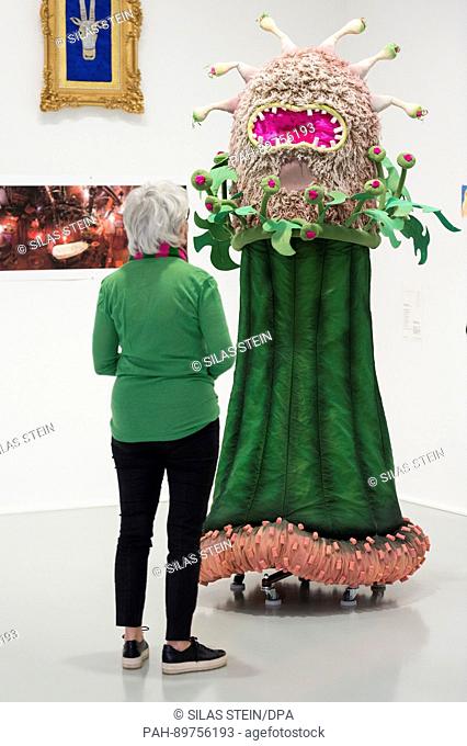 A visitor looks at a flower costume from the theatre piece ""Komm in meinen Wigwam"" from the year 2014/15 at the Theatre Dortmund