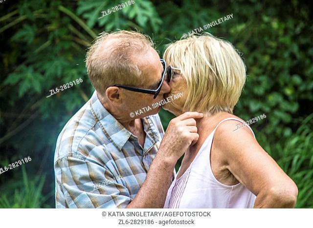 Older mature retired caucaisna couple talking and kissing