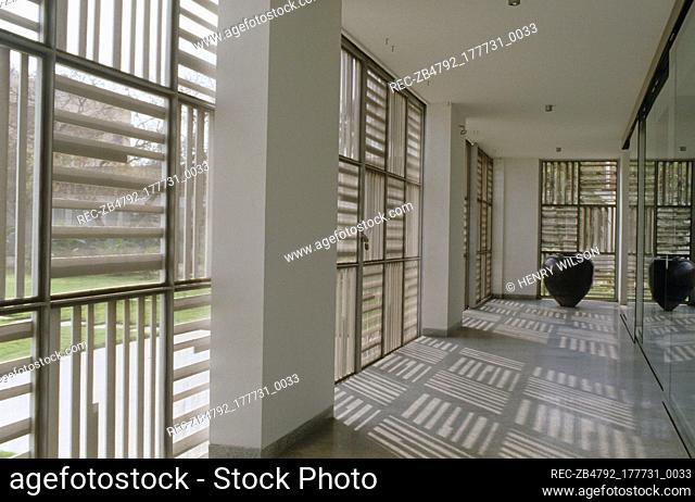 Light filtering through window panels into minimalist hallway