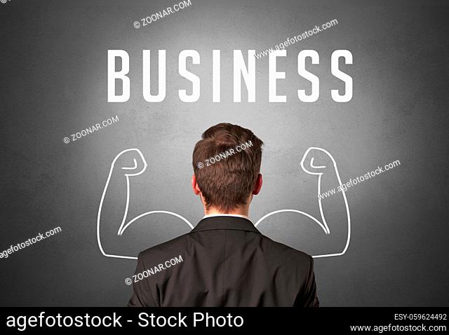 Rear view of a businessman with BUSINESS inscription, powerfull business concept