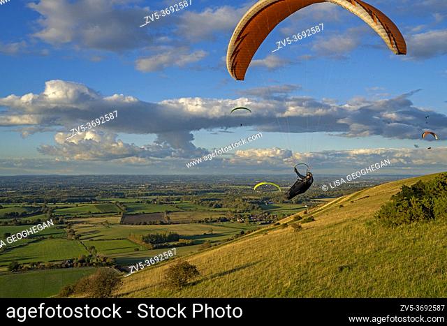 Paragliders flying above the weald on the South Downs National Park. Brighton, East Sussex. Uk