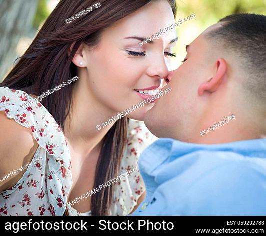 Happy Mixed Race Romantic Couple Kissing in the Park