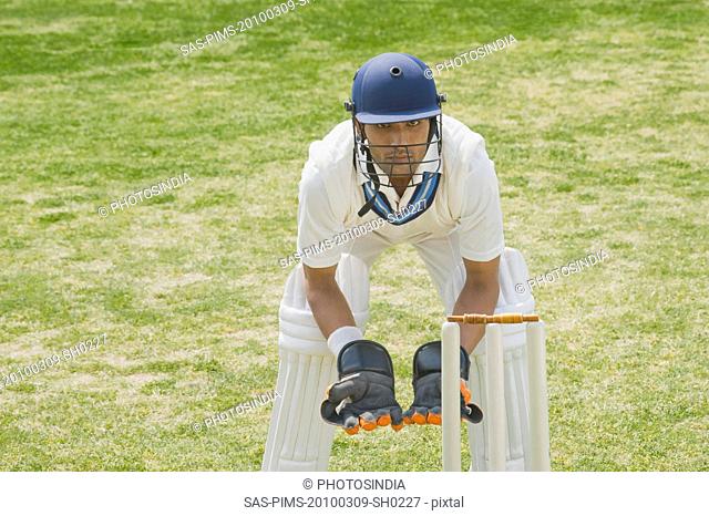 Cricket wicketkeeper behind stumps