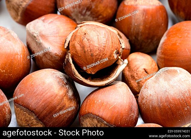 food background - many ripe whole and shelled hazelnuts