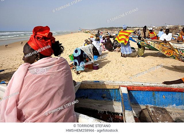 Senegal, Thies Region, Kayar, the beach and fishing harbour, women amoung the painted dugout canoes