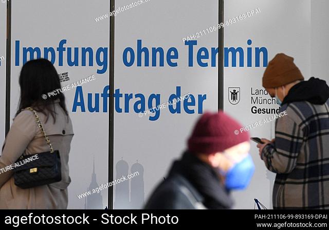 06 November 2021, Bavaria, Munich: Passers-by queue to get a Corona vaccination without an appointment. From Sunday on, stricter Corona regulations apply in...