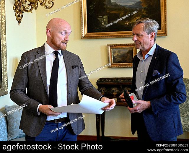 Former modern pentathlete and later coach Jan Bartu (right) receives the Order of the British Empire from the British Ambassador to the Czech Republic Matt...