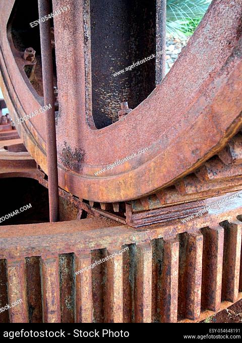 close up details of large old rusty steel industrial cog wheels