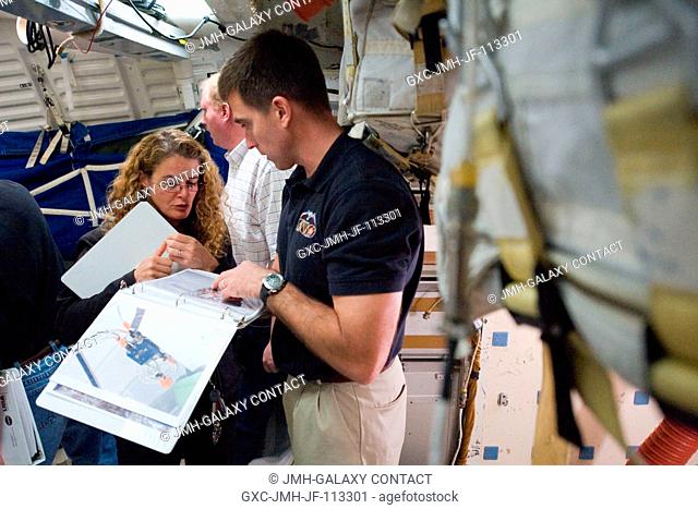 Canadian Space Agency astronaut Julie Payette and NASA astronaut Christopher Cassidy, both STS-127 mission specialists, participate in an ingressegress timeline...