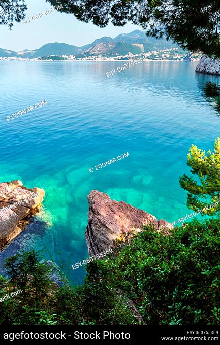 Beautiful morning coastline view with sea-green water surface and stony coast (Montenegro, Budva)