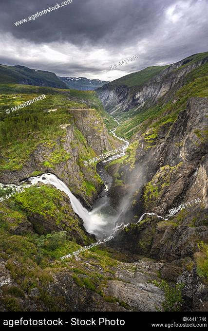 View into the river valley with waterfall Vøringfossen, river Bjoreio falls down a rock face, valley with river, Eidfjord, Norway, Europe