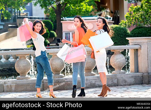 Young girlfriends go shopping shopping
