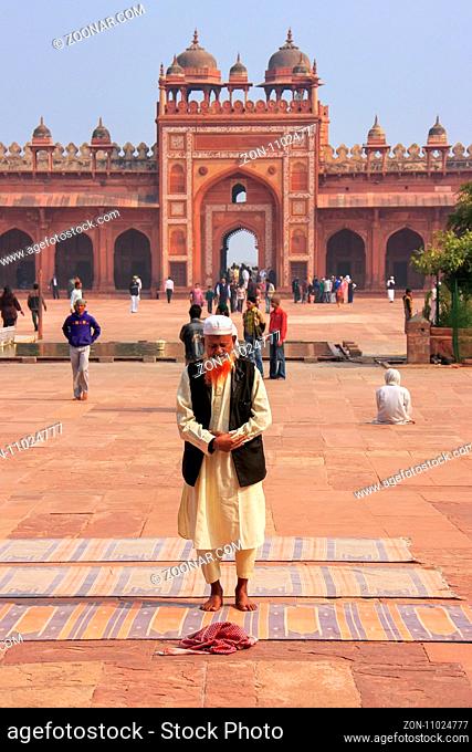 Local man standing in the courtyard of Jama Masjid in Fatehpur Sikri, Uttar Pradesh, India. The mosque was built in 1648 by Emperor Shah Jahan and dedicated to...